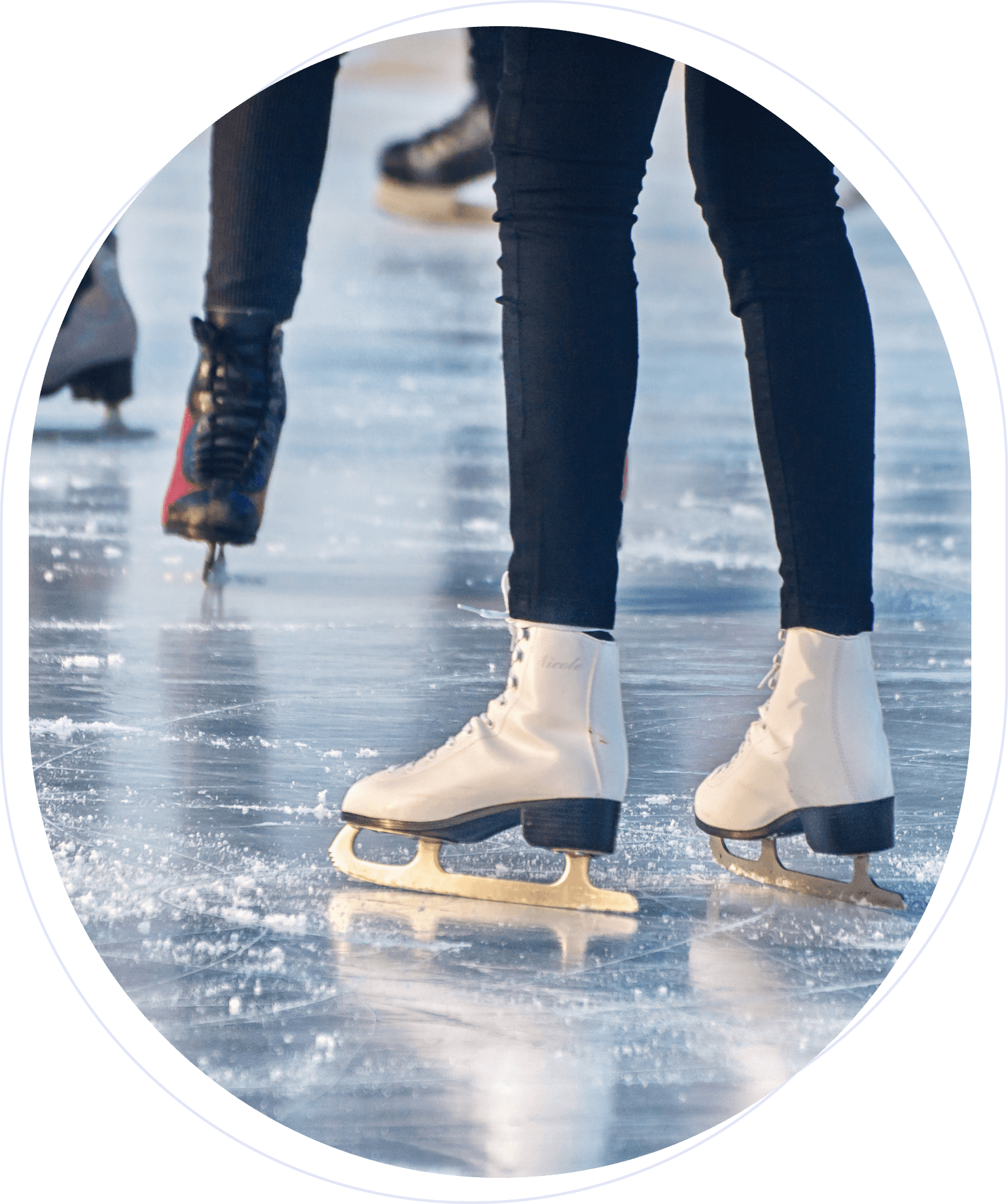 People ice skating on a rink, close-up of legs and skates, with a glossy ice surface.