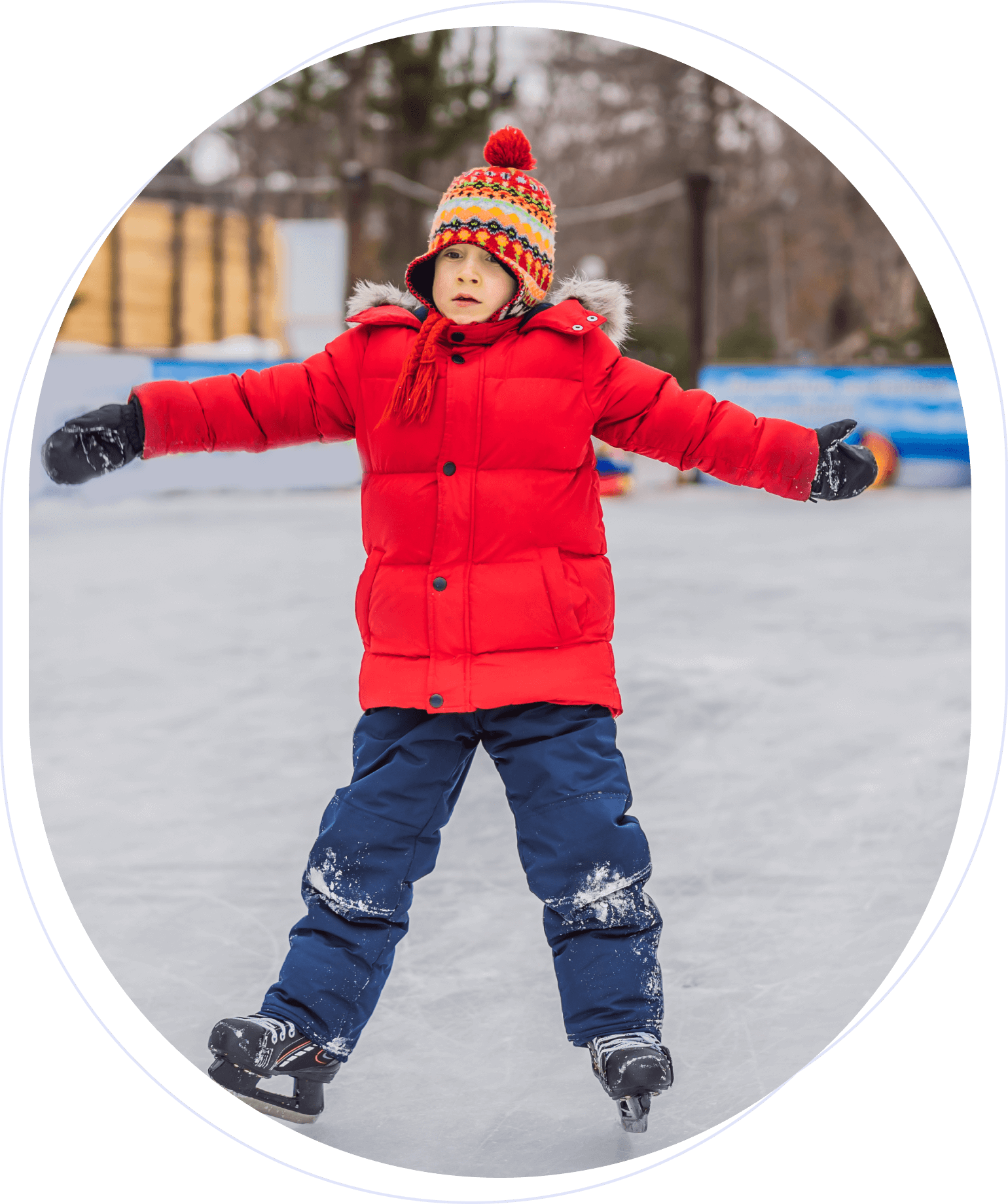 A child in a red coat and colorful hat ice skating outdoors on a snowy rink.